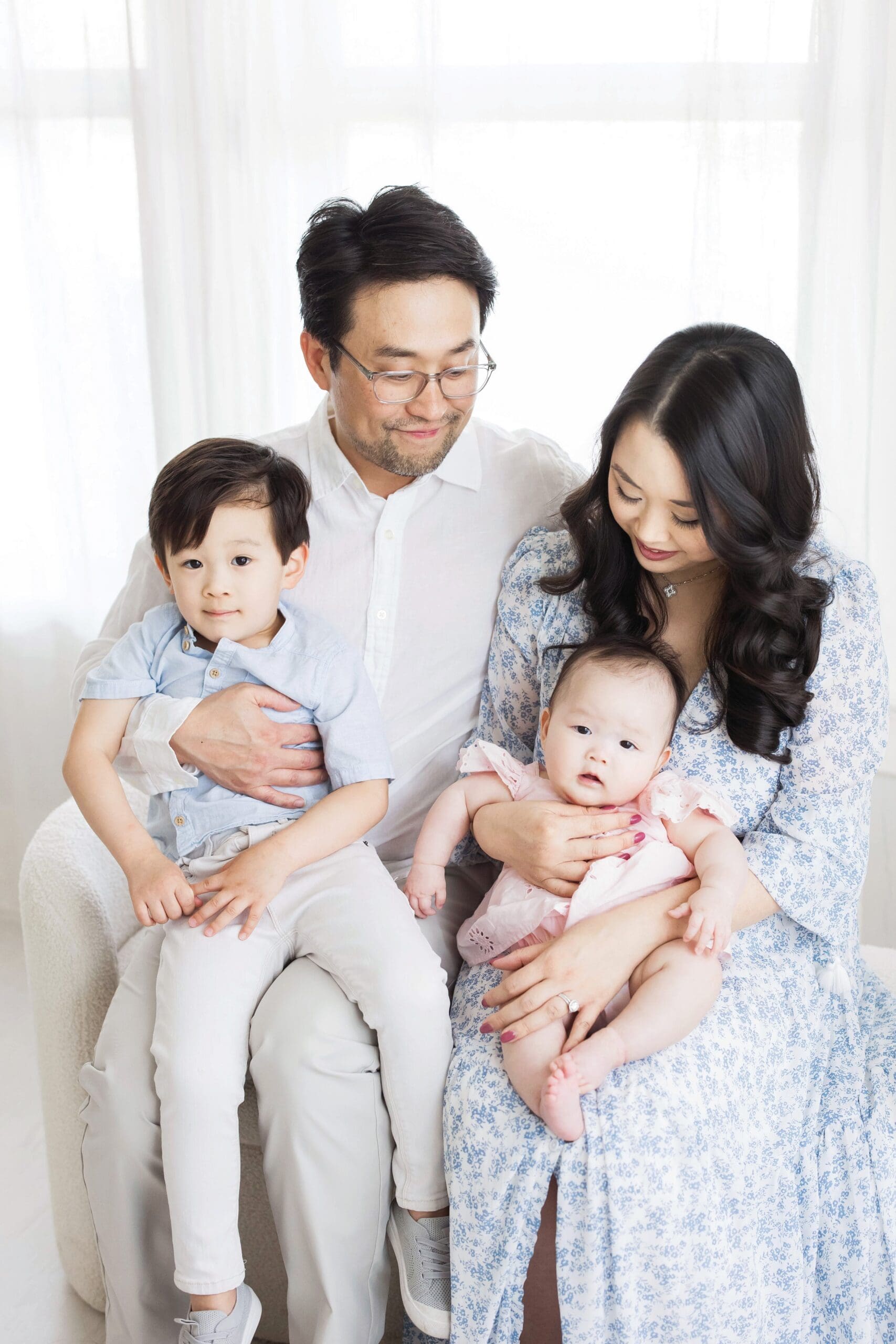 Parents holding their two young children during a family photography session